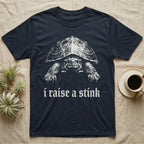 Musk Turtle Stink T-Shirt in Navy — Photo of a small musk turtle facing forward above the blackletter line i raise a stink