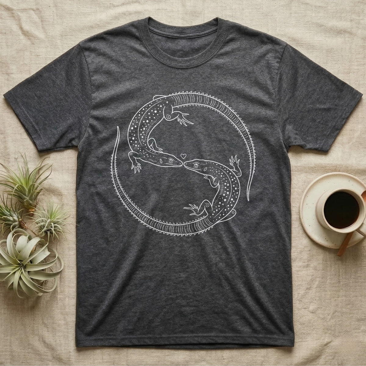 Ackie Monitor Roundel T-Shirt in Dark Heather — Two ackie monitors in fine white line art, mirrored at 180 degrees around a tiny heart, tails sweeping outward.