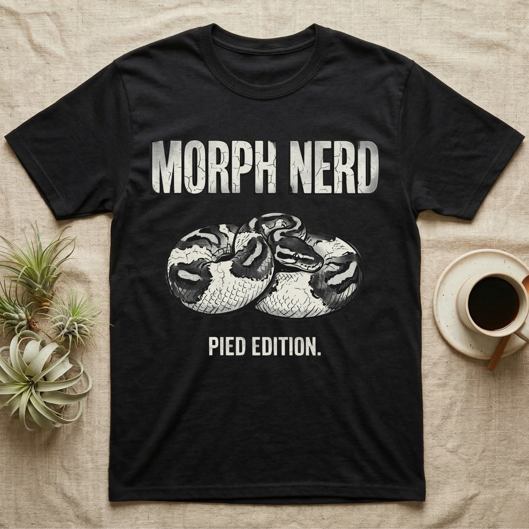 Pied Ball Python Morph T-Shirt in Black — Grunge type "Morph Nerd" with a small pied-morph ball python coiled mid-design and "Pied Edition" caption beneath.