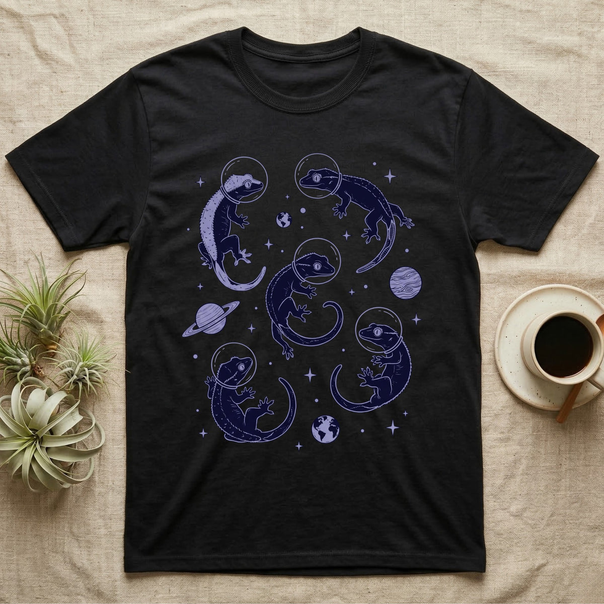 Crested Gecko Cosmic T-Shirt in Black — Vintage screen-print illustration of crested geckos in astronaut helmets floating in space, deep cosmic indigo monochromatic on dark background.