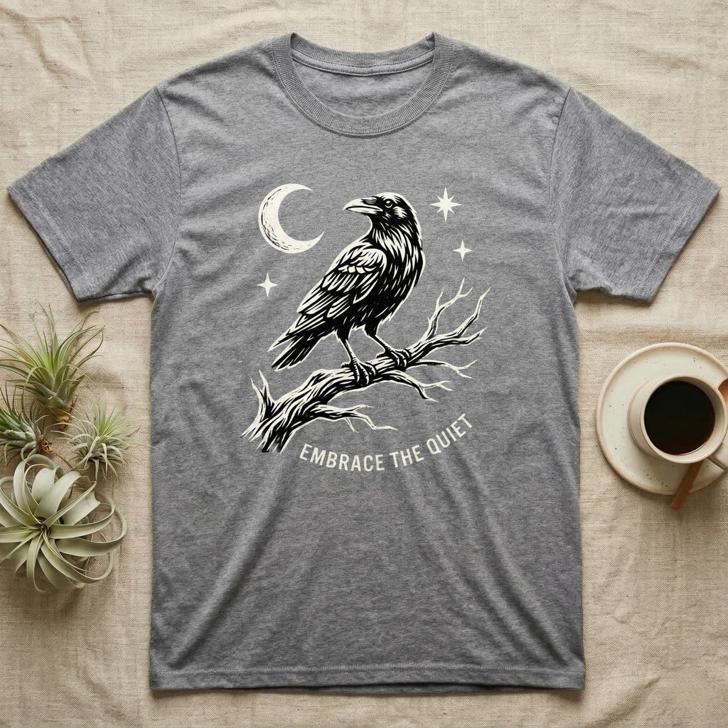 Grey t-shirt with a raven on a branch and text "Embrace the Quiet".
