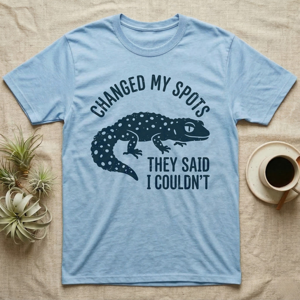 Leopard Gecko Spots T-Shirt in Light Blue — Navy silhouette of a spotted leopard gecko walking under arched words Changed My Spots, beside They Said I Couldn't