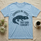 Leopard Gecko Spots T-Shirt in Light Blue — Navy silhouette of a spotted leopard gecko walking under arched words Changed My Spots, beside They Said I Couldn't
