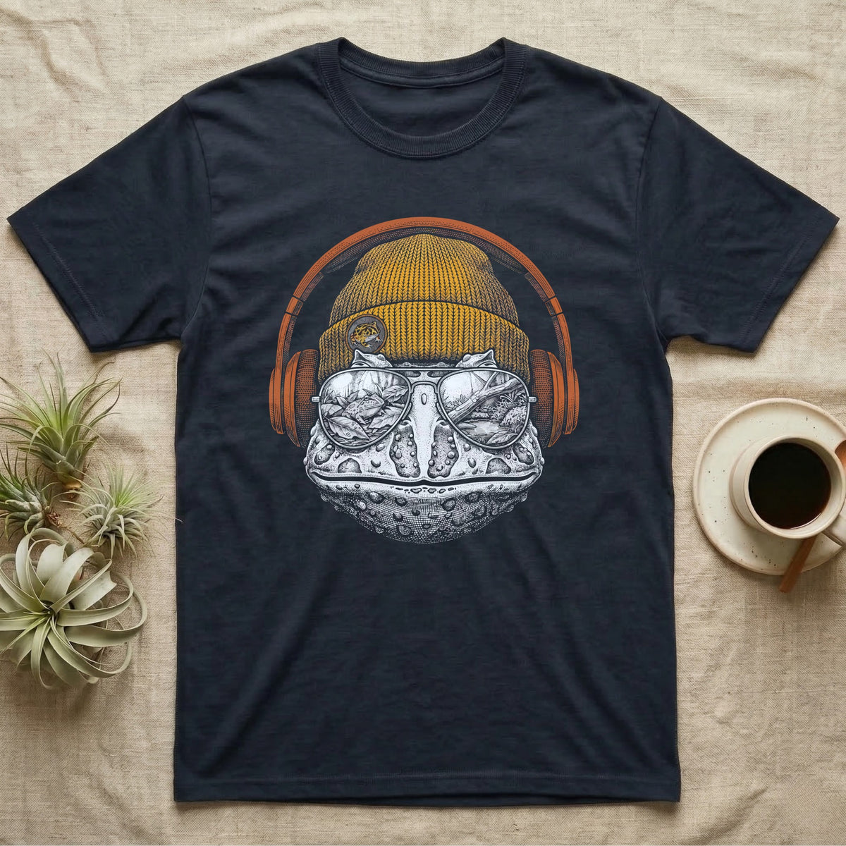 Pacman Frog Chill Beats T-Shirt in Navy — Engraved Pacman horned frog with wide bumpy skin in a beanie and headphones, aviators reflecting a woodland pond.