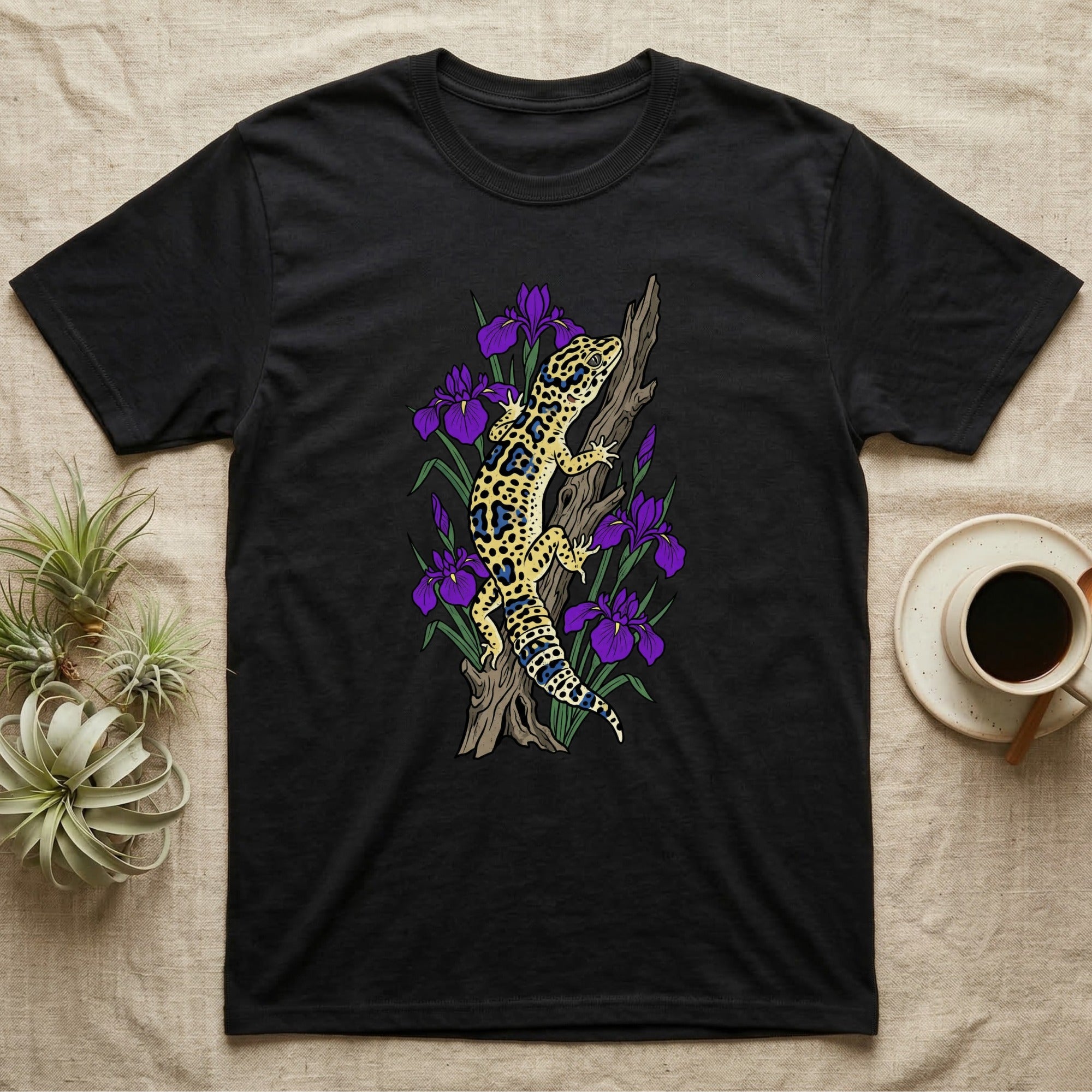 Black t-shirt with leopard gecko and purple irises on a log.