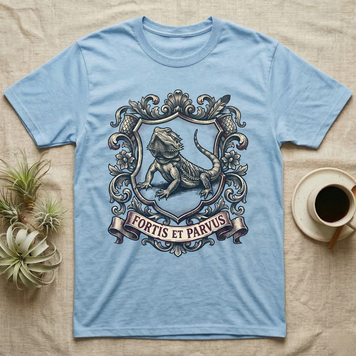 Bearded Dragon Heraldry T-Shirt in Light Blue — Engraved heraldic crest of a bearded dragon posed as a regal dragon on a shield with a ribbon banner.