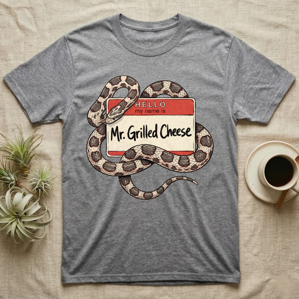 Grilled Cheese Corn Snake T-Shirt in Sport Grey — Flat retro illustration of a corn snake coiled through a "Hello my name is Mr. Grilled Cheese" name-tag badge.