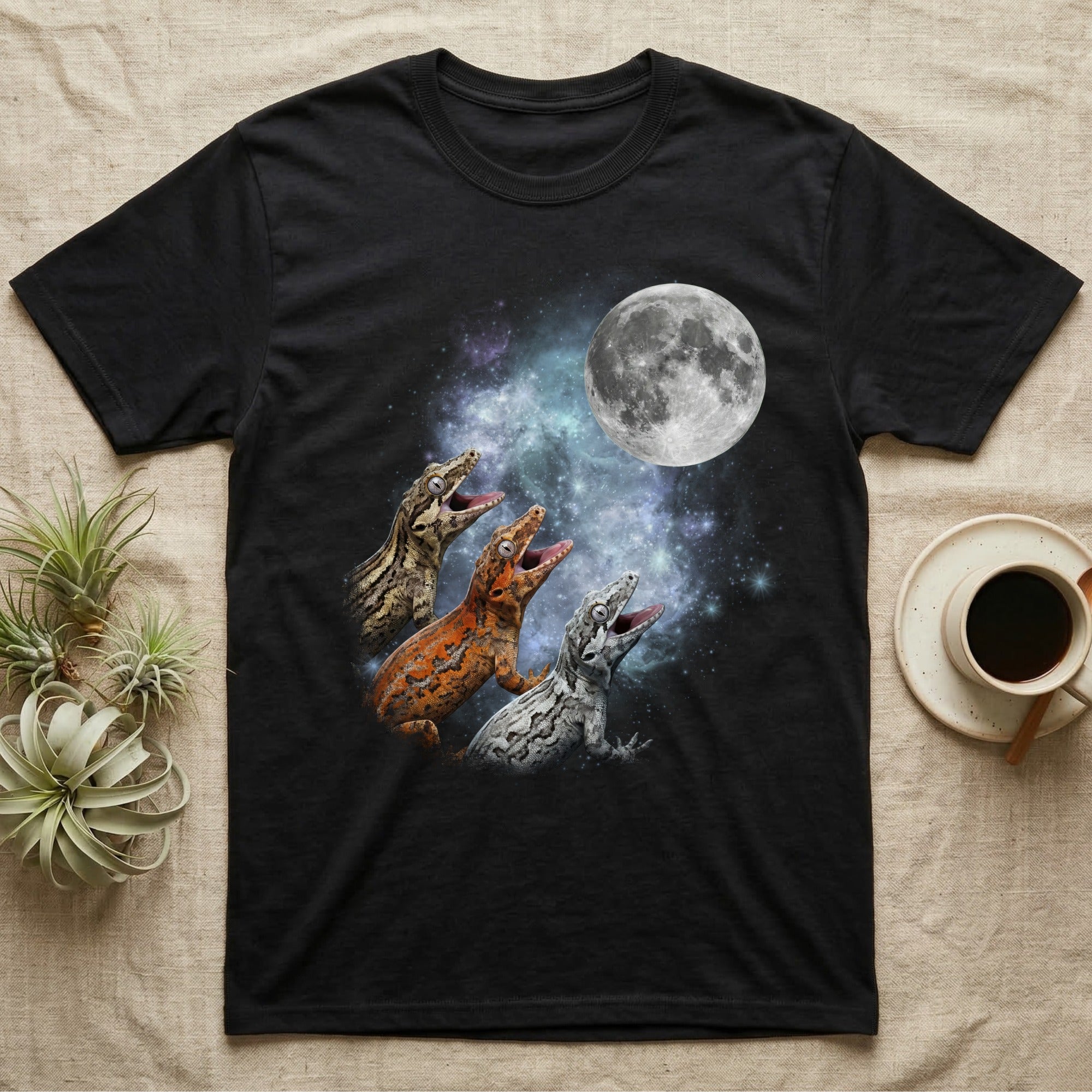 Gargoyle Gecko Moon Howl T-Shirt in Black — Three Gargoyle Gecko colour morphs howling at a full moon over a nebula on a dark grey t-shirt.