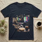 Veiled Chameleon TV Static T-Shirt in Navy — Veiled chameleon slouched in an armchair with a remote, its head glowing in retro TV test-pattern colour bars.