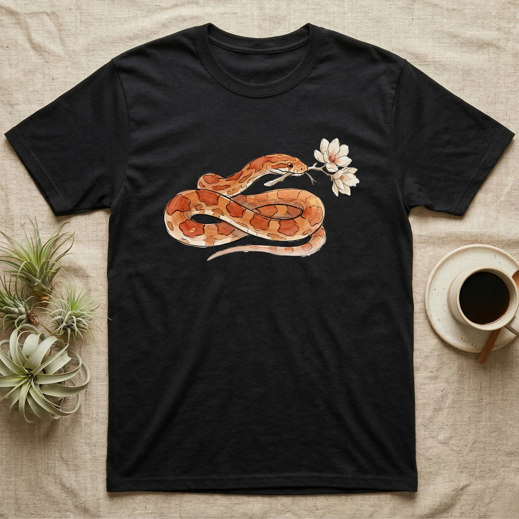 Corn Snake Blossom T-Shirt in Black — Watercolor illustration of an orange-and-cream corn snake holding a magnolia blossom sprig, on a dark grey t-shirt.