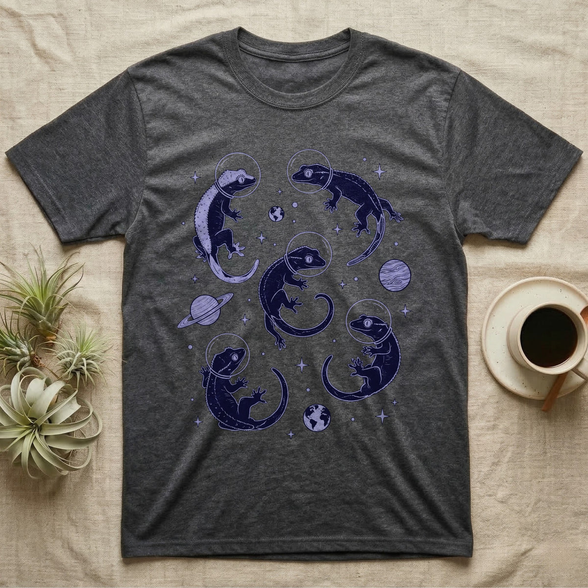 Crested Gecko Cosmic T-Shirt in Dark Heather — Vintage screen-print illustration of crested geckos in astronaut helmets floating in space, deep cosmic indigo monochromatic on dark background.