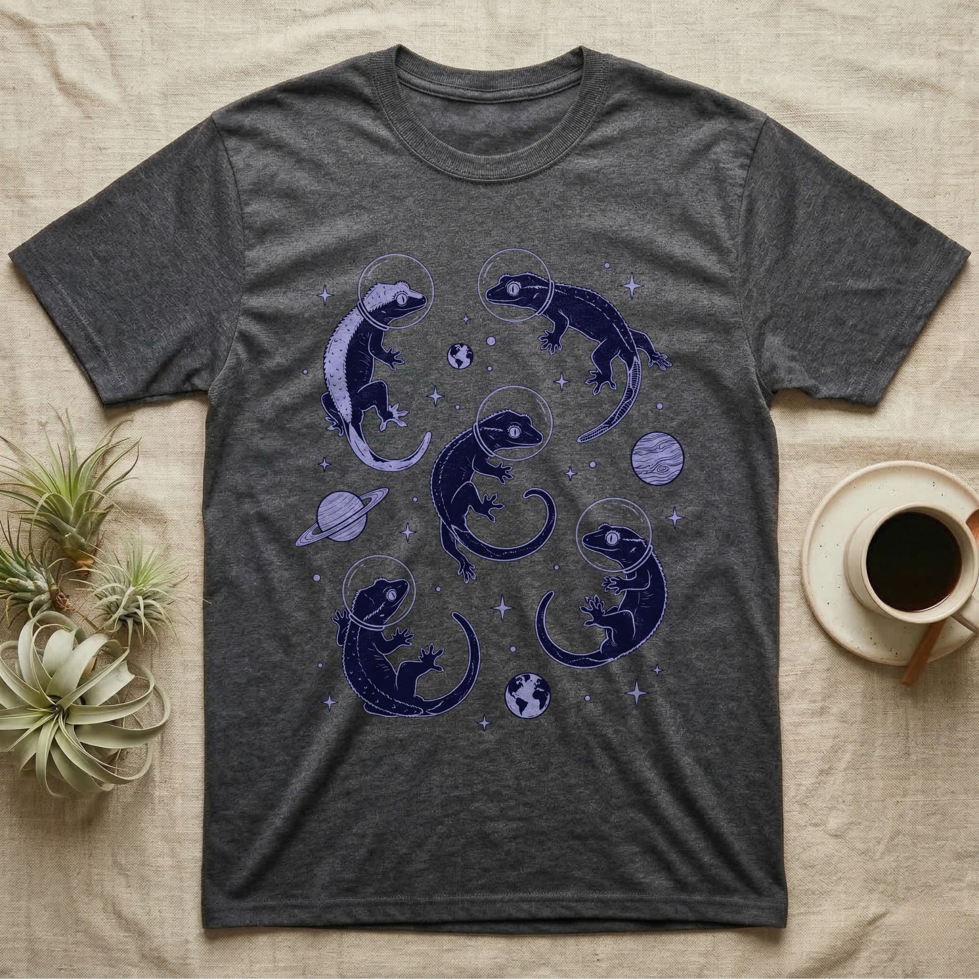 Crested Gecko Cosmic T-Shirt in Dark Heather — Vintage screen-print illustration of crested geckos in astronaut helmets floating in space, deep cosmic indigo monochromatic on dark background.