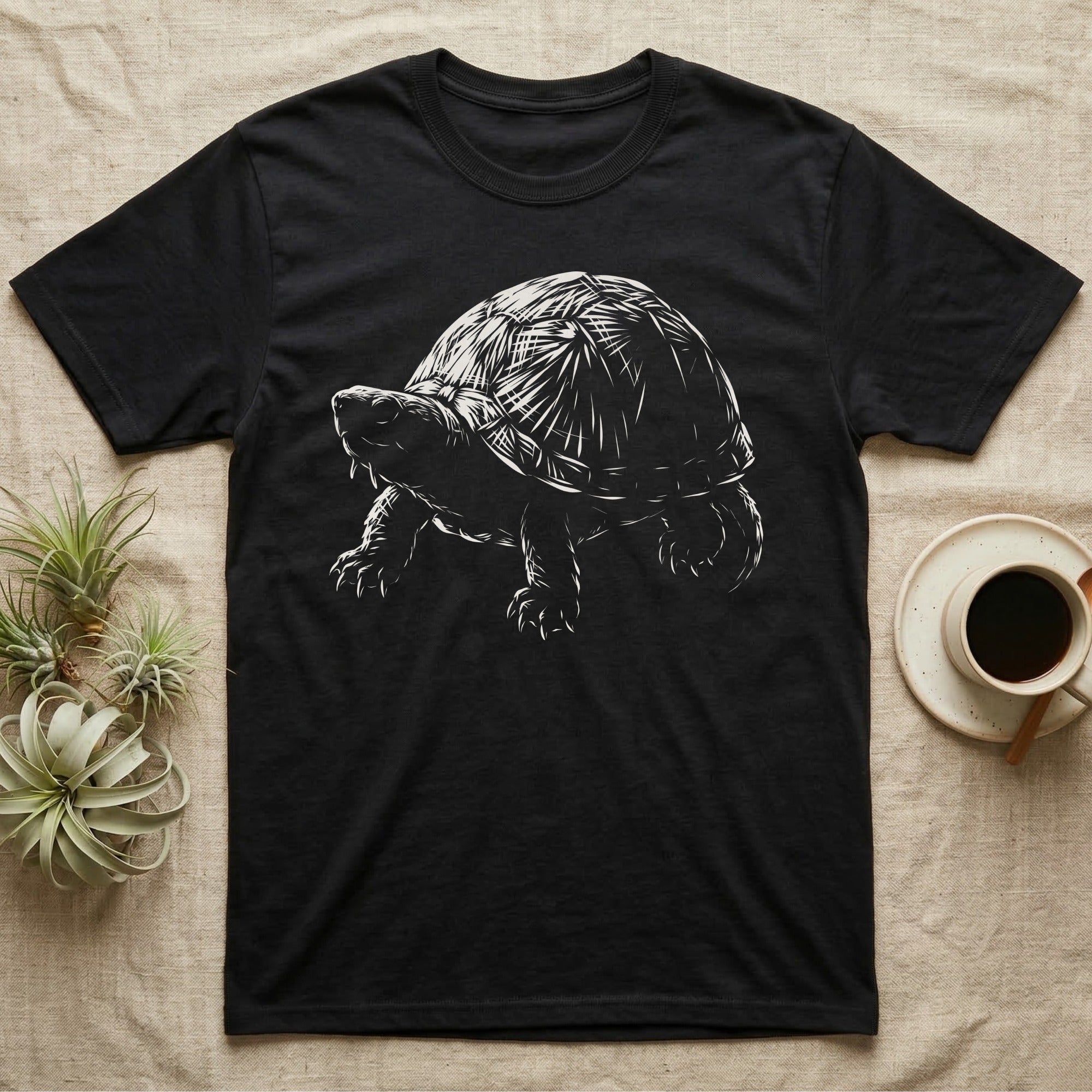 Musk Turtle Stinkpot T-Shirt in Black — Rim-lit negative-space illustration of a small musk turtle in badge-scale portrait against a dark ground.