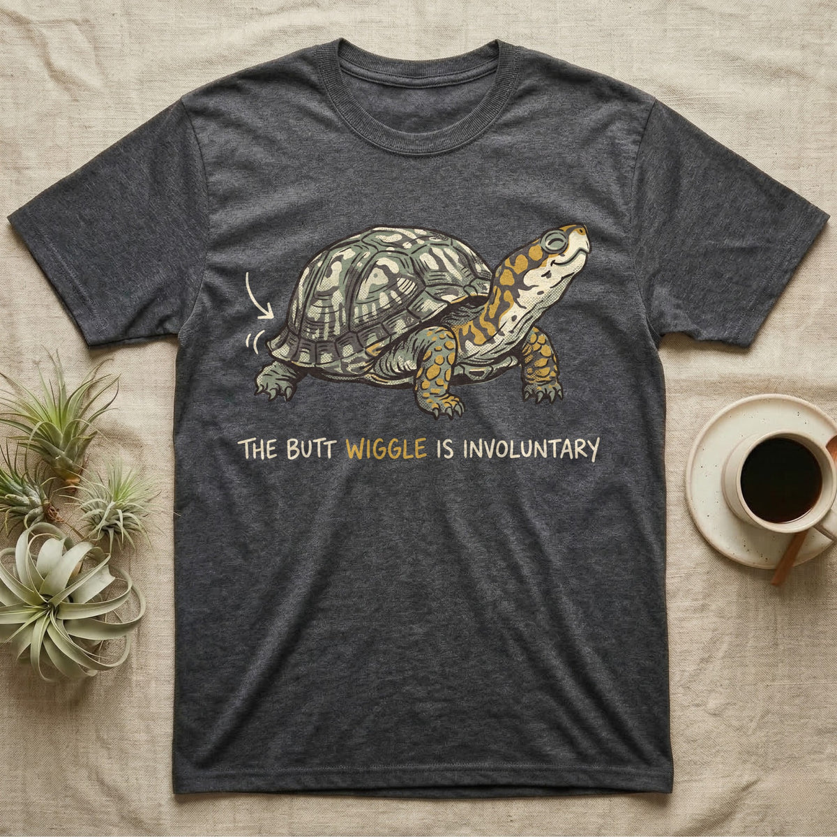 Box Turtle Wiggle T-Shirt in Dark Heather — Retro-illustration of a box turtle mid shell-scratch with a hand-drawn arrow at its wiggling rear and a deadpan marker caption.