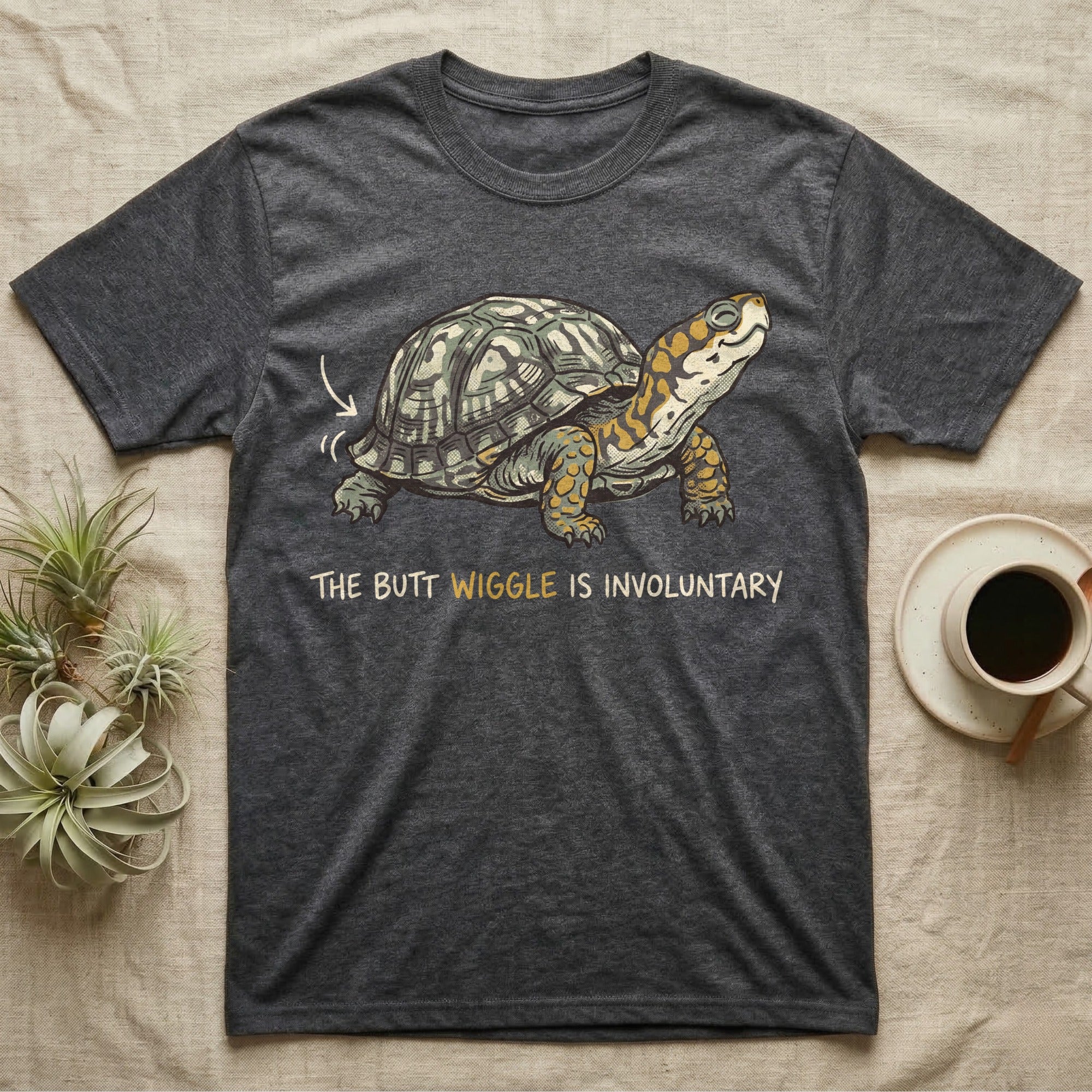 Box Turtle Wiggle T-Shirt in Dark Heather — Retro-illustration of a box turtle mid shell-scratch with a hand-drawn arrow at its wiggling rear and a deadpan marker caption.