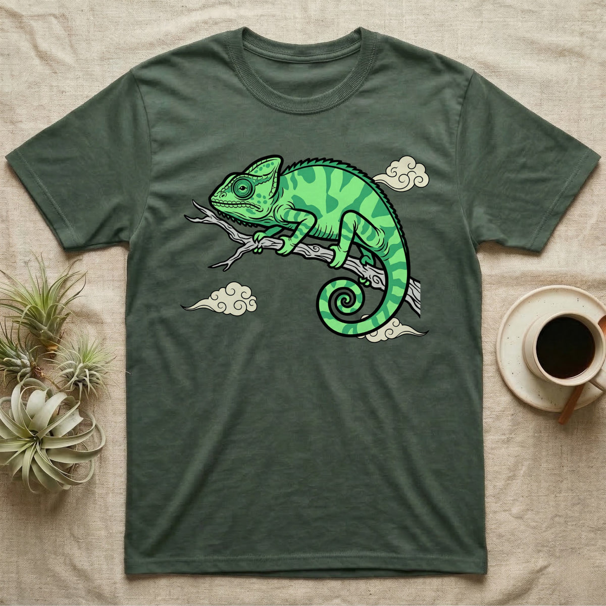 Green t-shirt with a cartoon chameleon design on a branch.