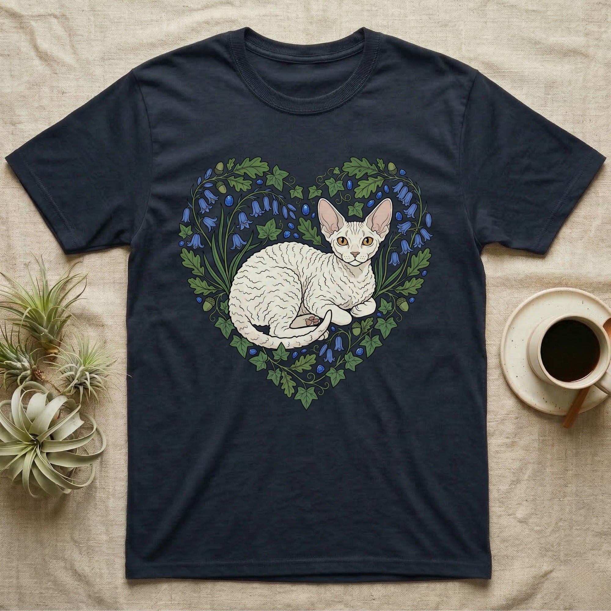 Dark t-shirt with white Cornish Rex cat in a heart-shaped floral design.