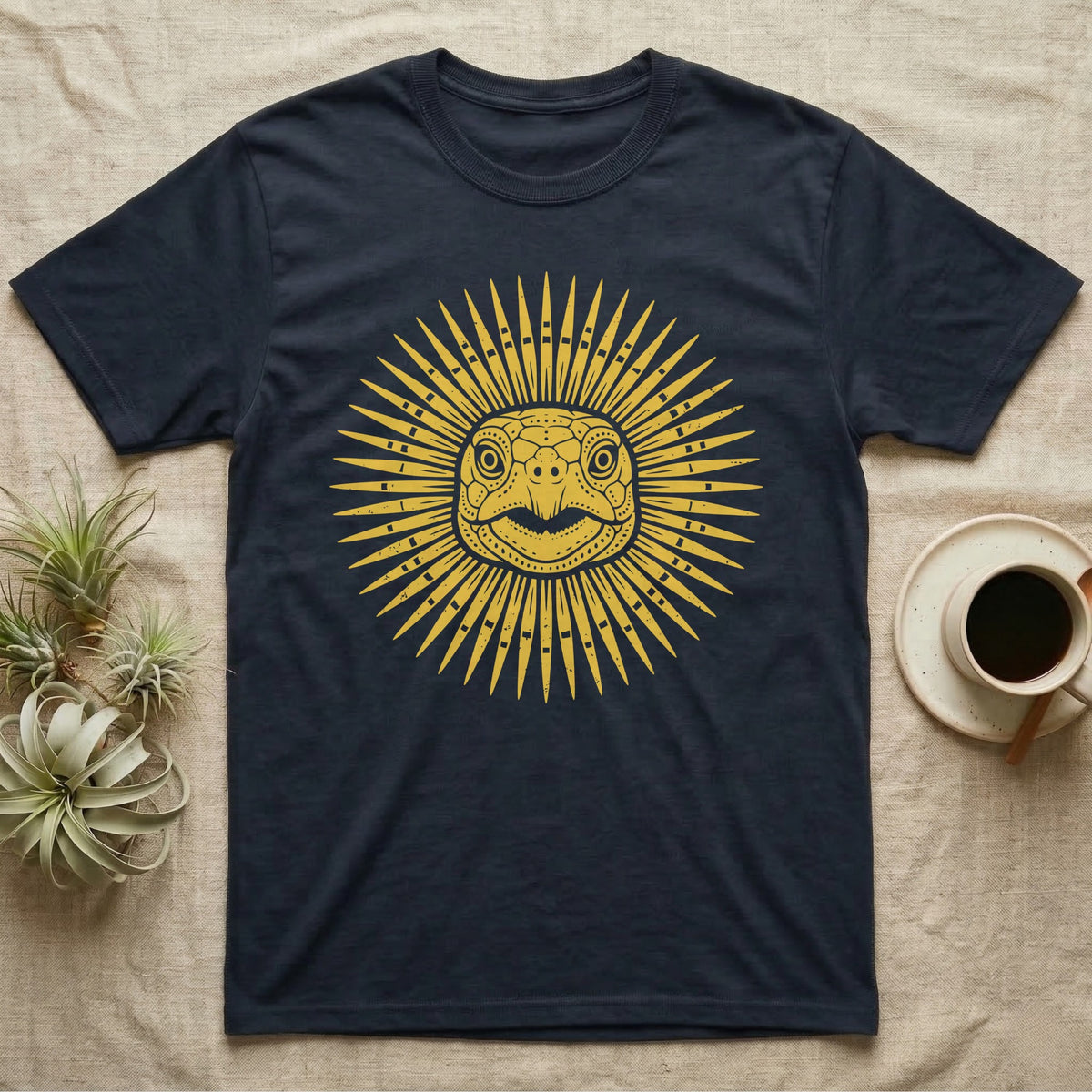 Hermann's Tortoise Sunburst T-Shirt in Navy — Horn-yellow woodblock Hermann's tortoise seen head-on, its shell scutes radiating outward into a sunburst medallion.