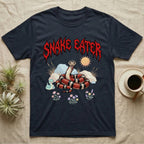 California Kingsnake Feral T-Shirt in Navy — Banded California kingsnake coiled with a tiny companion snake under a jagged blood-red metal wordmark and pastel scene.