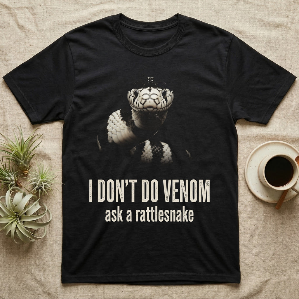 Deadpan photographic mugshot of a California kingsnake raised head-level to the camera above the distressed text I Don't Do Venom, ask a rattlesnake. — shown on a Black tee.