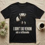Deadpan photographic mugshot of a California kingsnake raised head-level to the camera above the distressed text I Don't Do Venom, ask a rattlesnake. — shown on a Black tee.