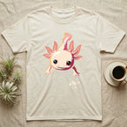 Cute chibi illustration of a smiling cream and coral-pink axolotl floating with splashing water droplets, no on-shirt text. — shown on a Natural tee.