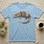 Light blue t-shirt with a colorful, patchwork lizard graphic and blue tongue.