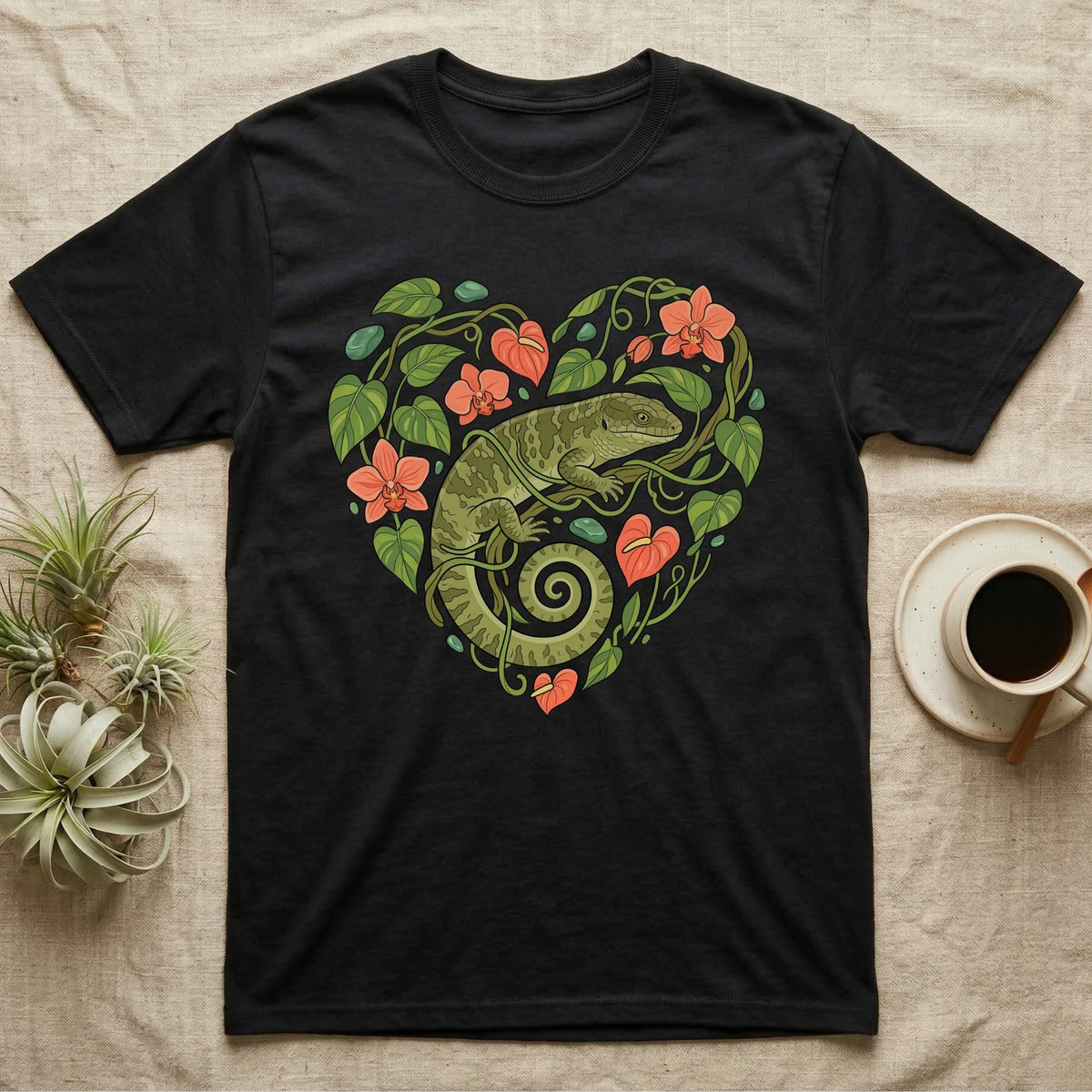 Black t-shirt with a green lizard and floral heart design.