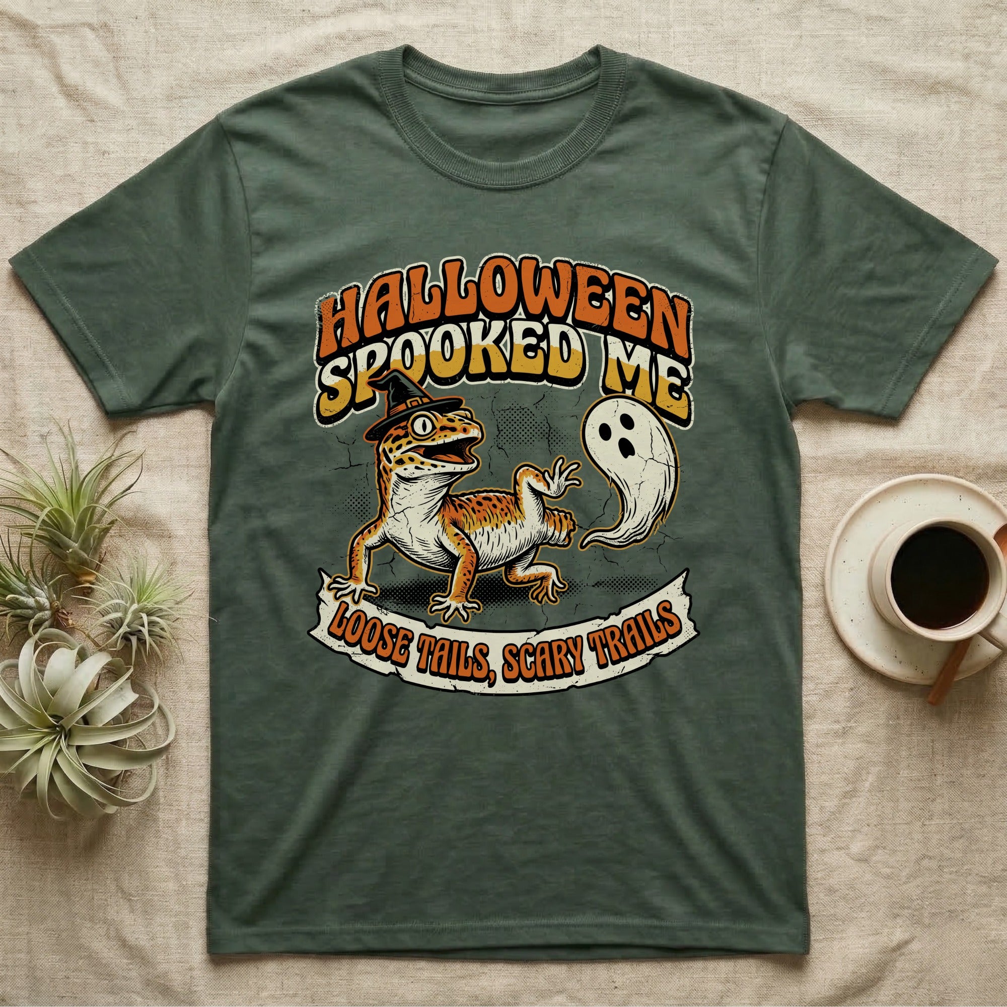 Leopard Gecko Spooked Me T-Shirt in Military Green — Distressed graphic of a shocked leopard gecko in a witch hat beside its ghost-costumed dropped tail, "Halloween Spooked Me."