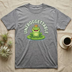 T-shirt with a smiling frog wearing a crown on a lily pad, "UNFROGGTTABLE" text.