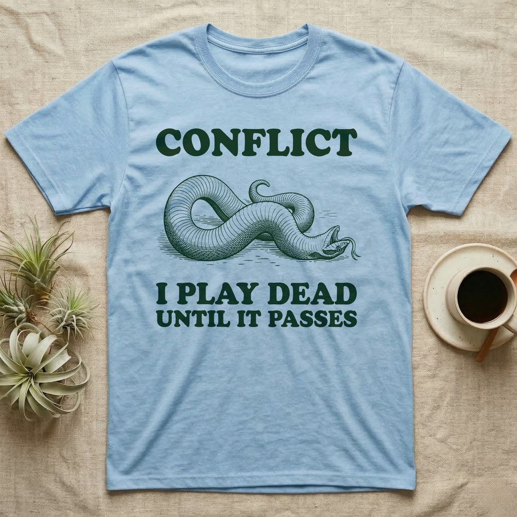 Hognose Conflict T-Shirt in Light Blue — Engraved western hognose snake twisted over and playing dead with its tongue out, between the words CONFLICT and I PLAY DEAD UNTIL IT PASSES.