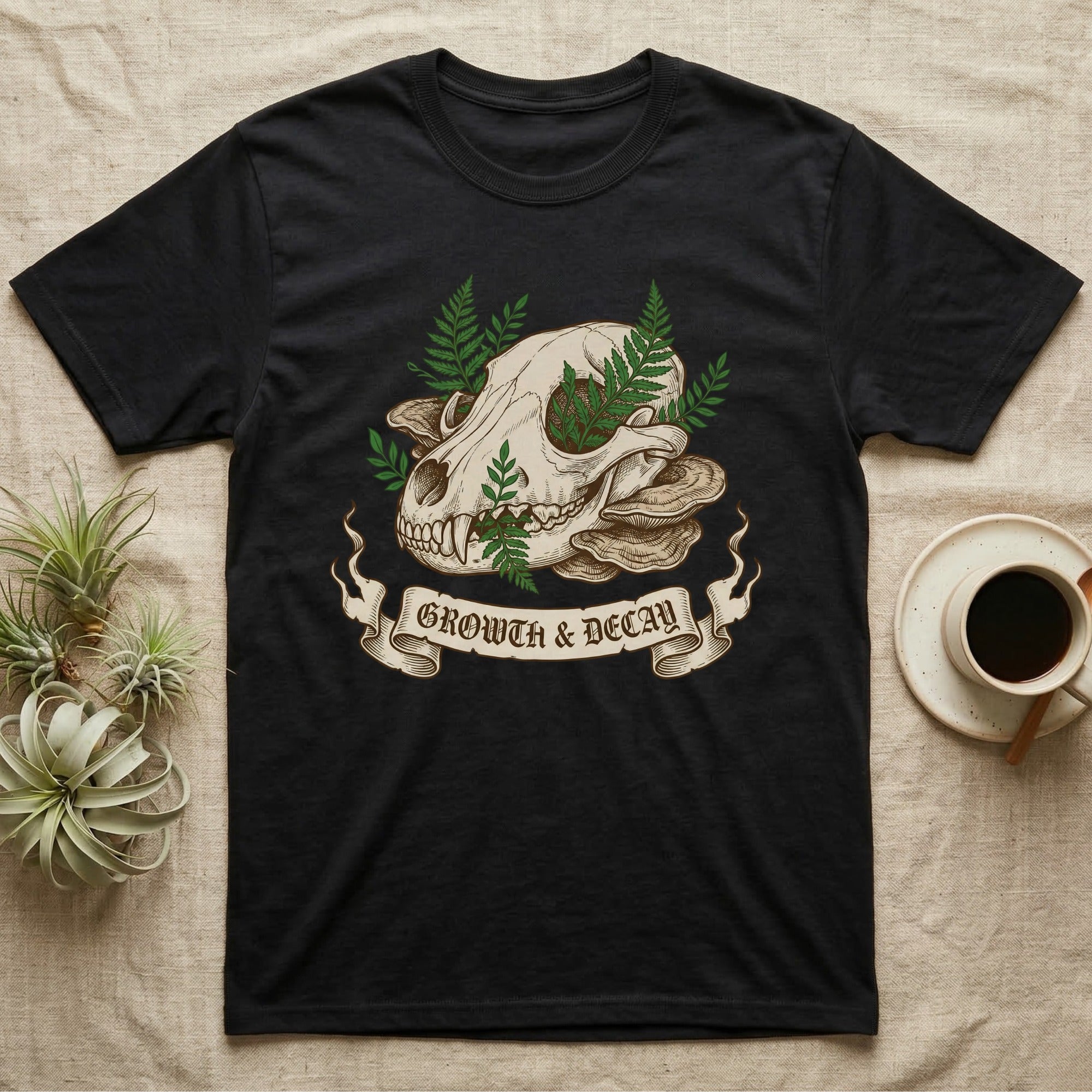 Black t-shirt featuring skull, mushrooms, ferns, and "Growth & Decay" banner.