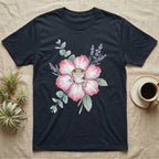 Dark t-shirt with a watercolor illustration of a gecko on a pink flower with lavender sprigs.