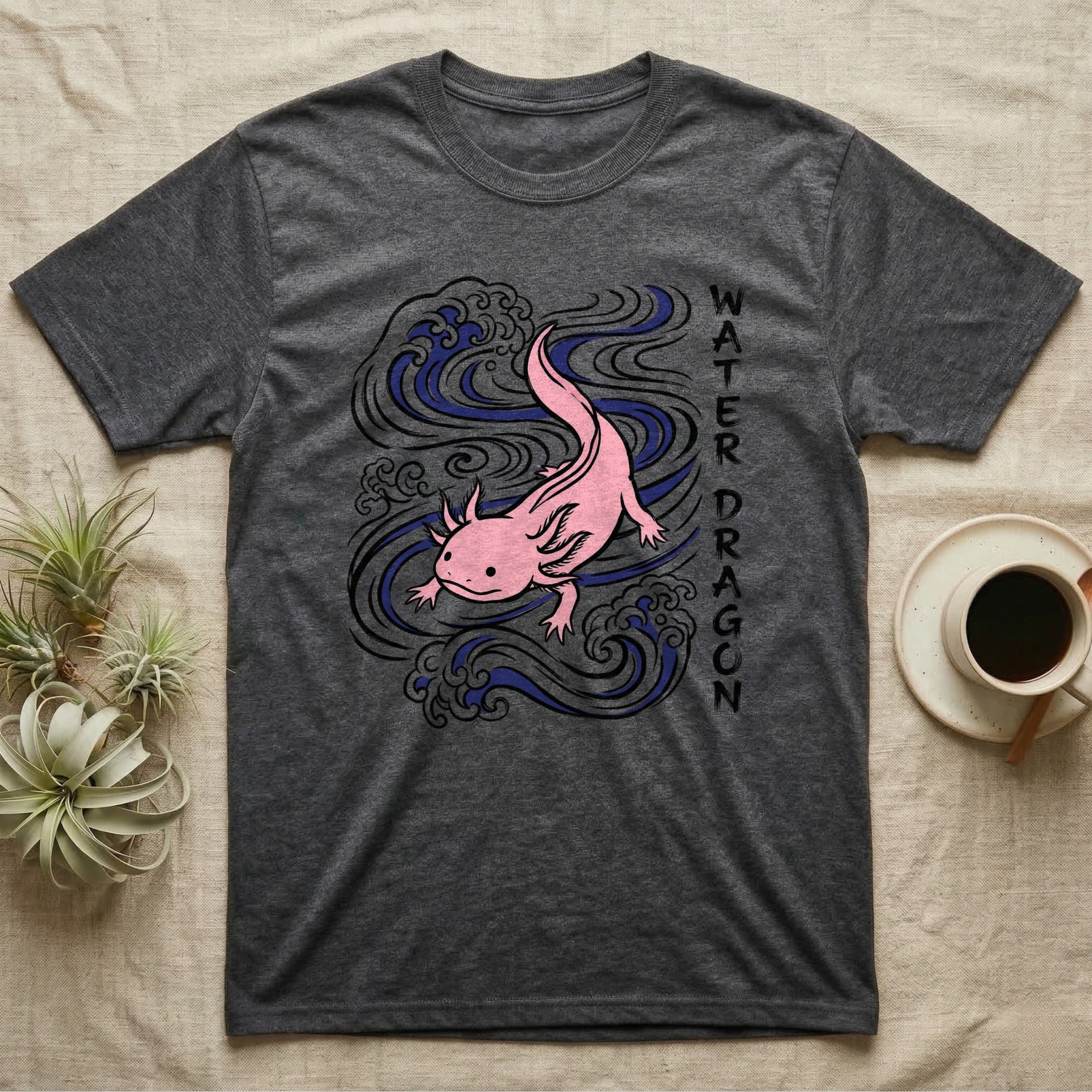 Dark grey t-shirt with a pink axolotl and blue water waves design.