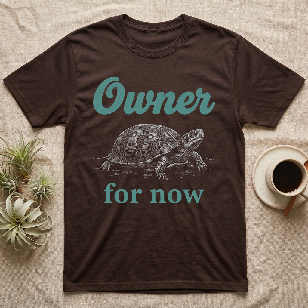 Box Turtle Owner T-Shirt in Dark Chocolate — White engraved eastern box turtle walking forward between the word Owner in teal script and for now in teal serif type.