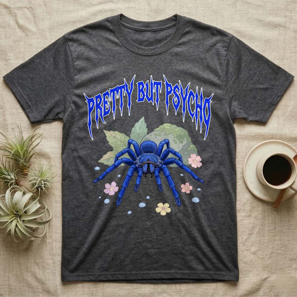 Cobalt Blue Tarantula Feral T-Shirt in Dark Heather — Cobalt blue tarantula with electric-blue legs under jagged cobalt metal text PRETTY BUT PSYCHO with pastel blossoms