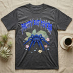 Cobalt Blue Tarantula Feral T-Shirt in Dark Heather — Cobalt blue tarantula with electric-blue legs under jagged cobalt metal text PRETTY BUT PSYCHO with pastel blossoms