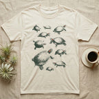 Red-Eared Slider Specimen T-Shirt in Natural — One red-eared slider repeated ten times in olive-green screen-print specks, each at a different size and angle, with a small red stripe behind every eye.