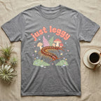 Vietnamese Centipede Baby T-Shirt in Sport Grey — Many-legged Vietnamese centipede curving among pastel ferns and toadstools under puffy coral text "just leggy".
