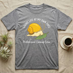 Grey t-shirt with a cartoon snail on a leaf and text: Living Life at My Own Pace, Professional Cleanup Crew.