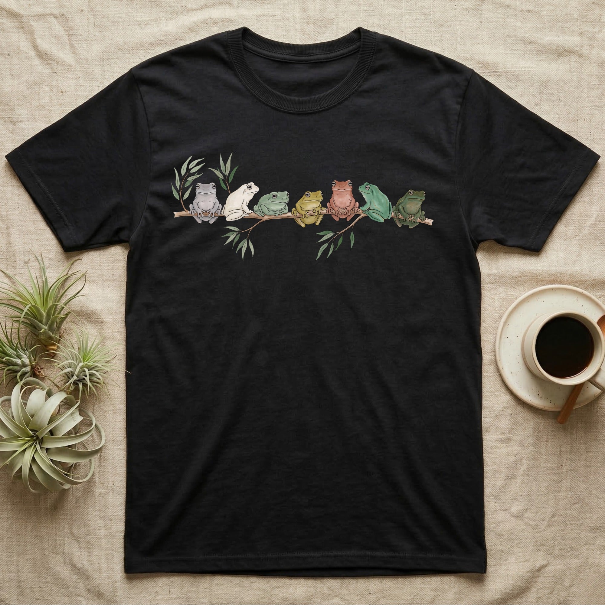 White's Tree Frog Canopy Crew T-Shirt in Black — Watercolor illustration of seven White's tree frogs in different colour phases on a eucalyptus branch, dark grey T-shirt design.