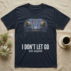 Deadpan close-up mugshot of a blue-grey tokay gecko on black, captioned I don't let go, ask anyone. — shown on a Navy tee.