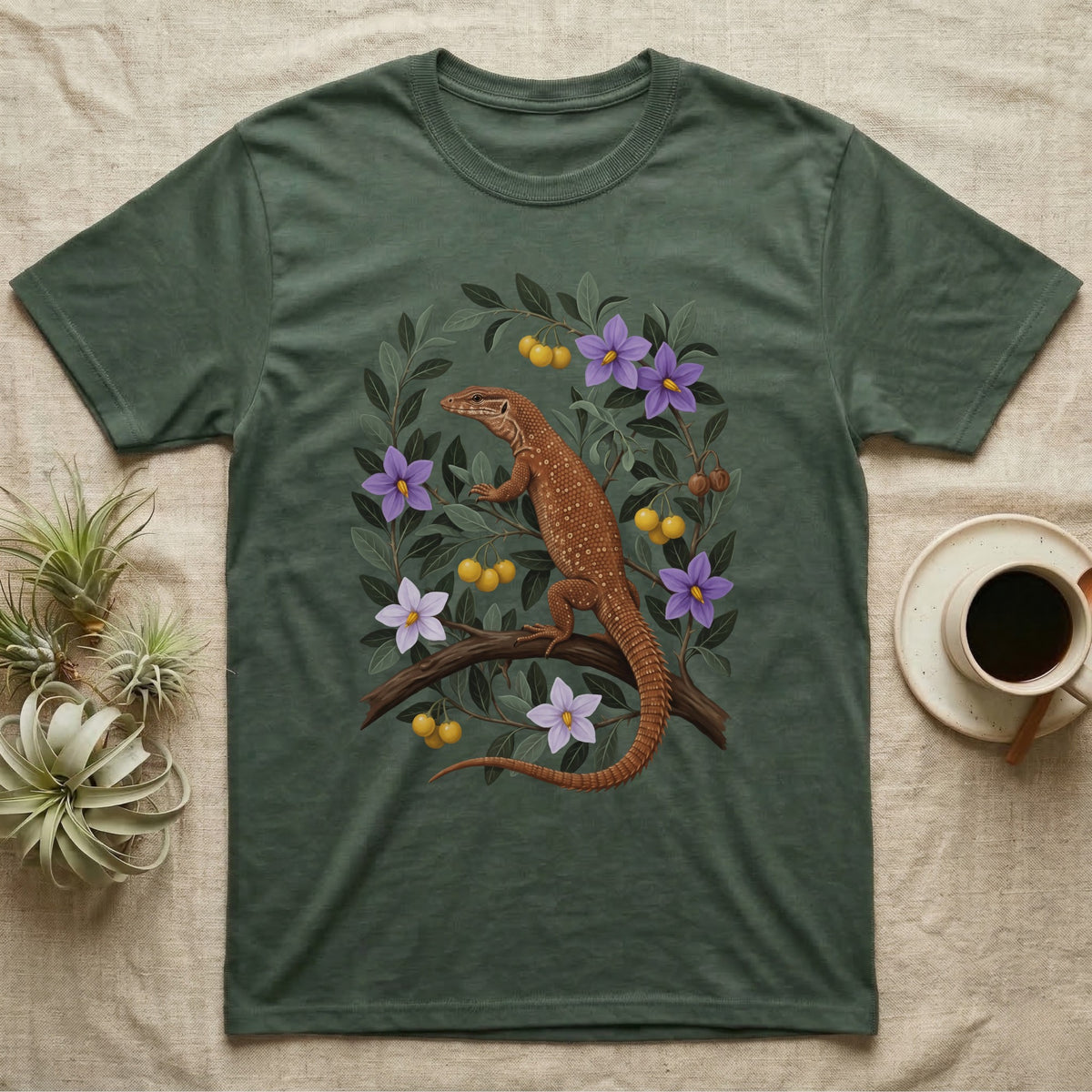 Ackie Monitor Botanical T-Shirt in Military Green — Naturalist oil painting of a red ackie monitor on a branch inside an oval bower of bush tomato with violet flowers and yellow fruit.