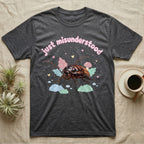 Madagascar Hissing Cockroach Baby T-Shirt in Dark Heather — Pastel Madagascar hissing cockroach among leaves, mushroom and moss, puffy pink wordmark "just misunderstood" above.