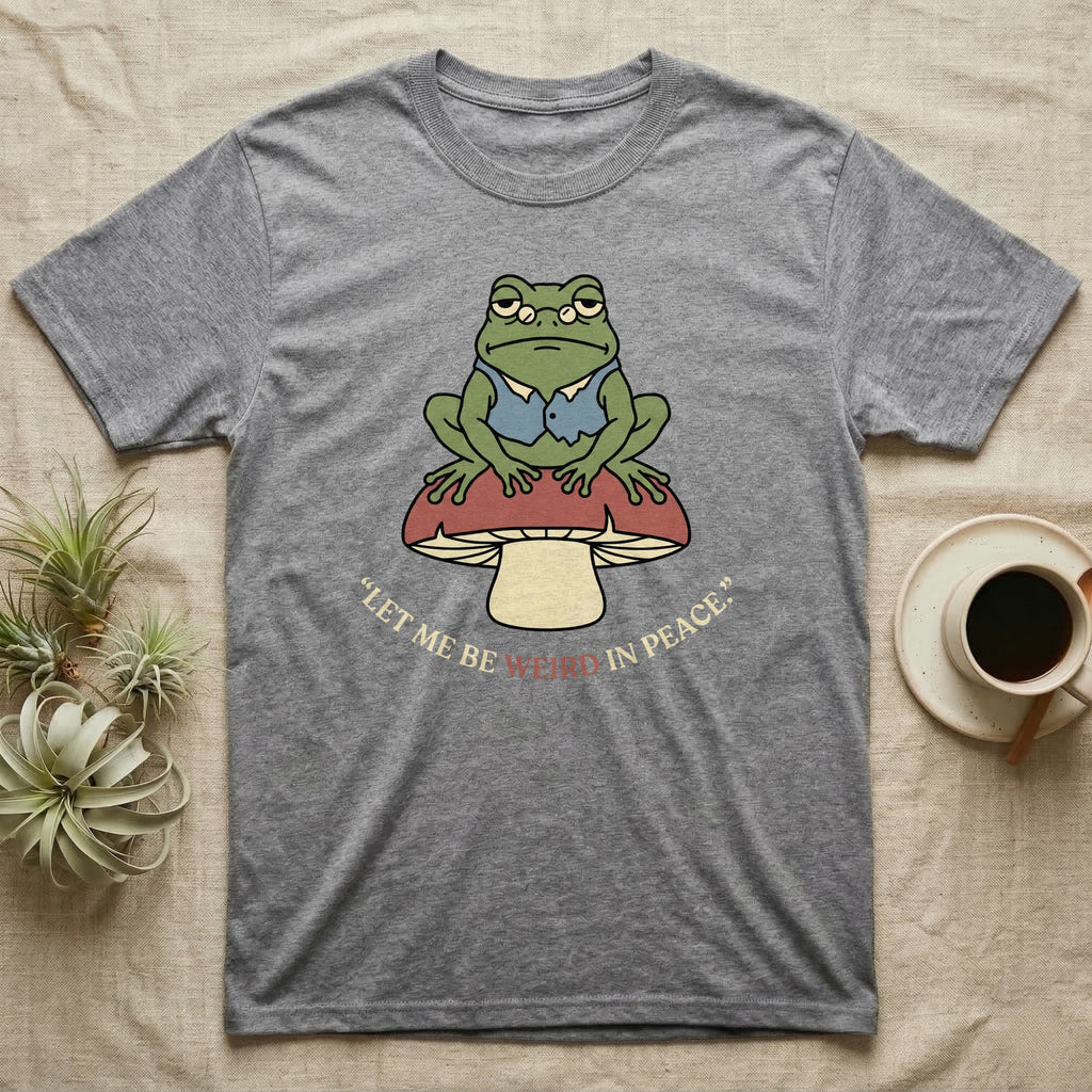 Grey t-shirt with frog on mushroom graphic and "Let me be weird in peace."
