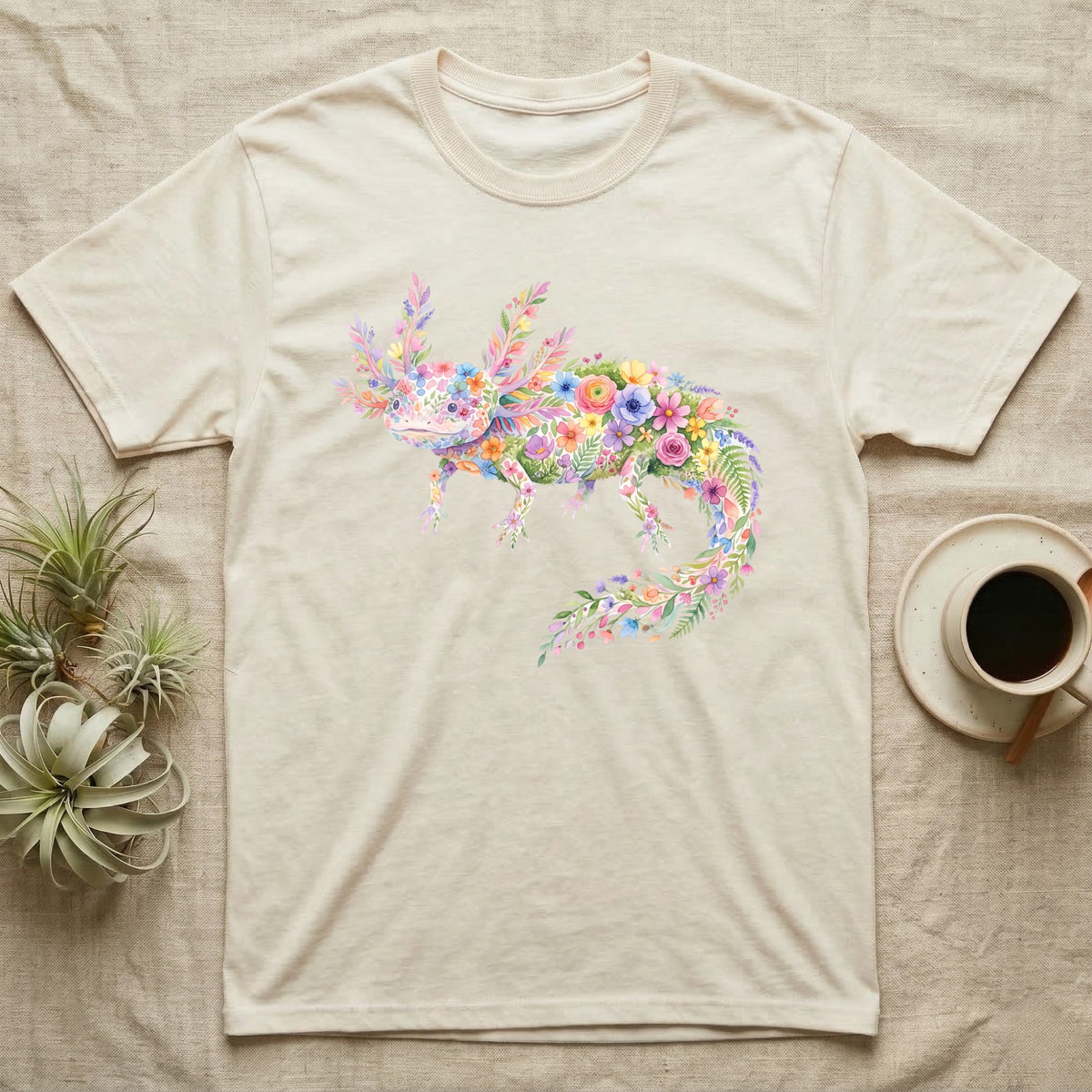 Axolotl Watercolour Mosaic T-Shirt in Natural — Watercolour mosaic axolotl made of painted flowers and leaf blades, gill plumes fanned, petals trailing from its tail