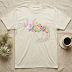 Axolotl Watercolour Mosaic T-Shirt in Natural — Watercolour mosaic axolotl made of painted flowers and leaf blades, gill plumes fanned, petals trailing from its tail