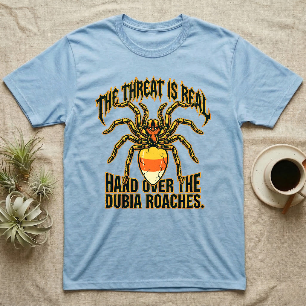 Tarantula Threat Dubia Roaches T-Shirt in Light Blue — Metal-style tarantula in threat posture with a candy-corn abdomen, "The Threat Is Real, Hand Over the Dubia Roaches."