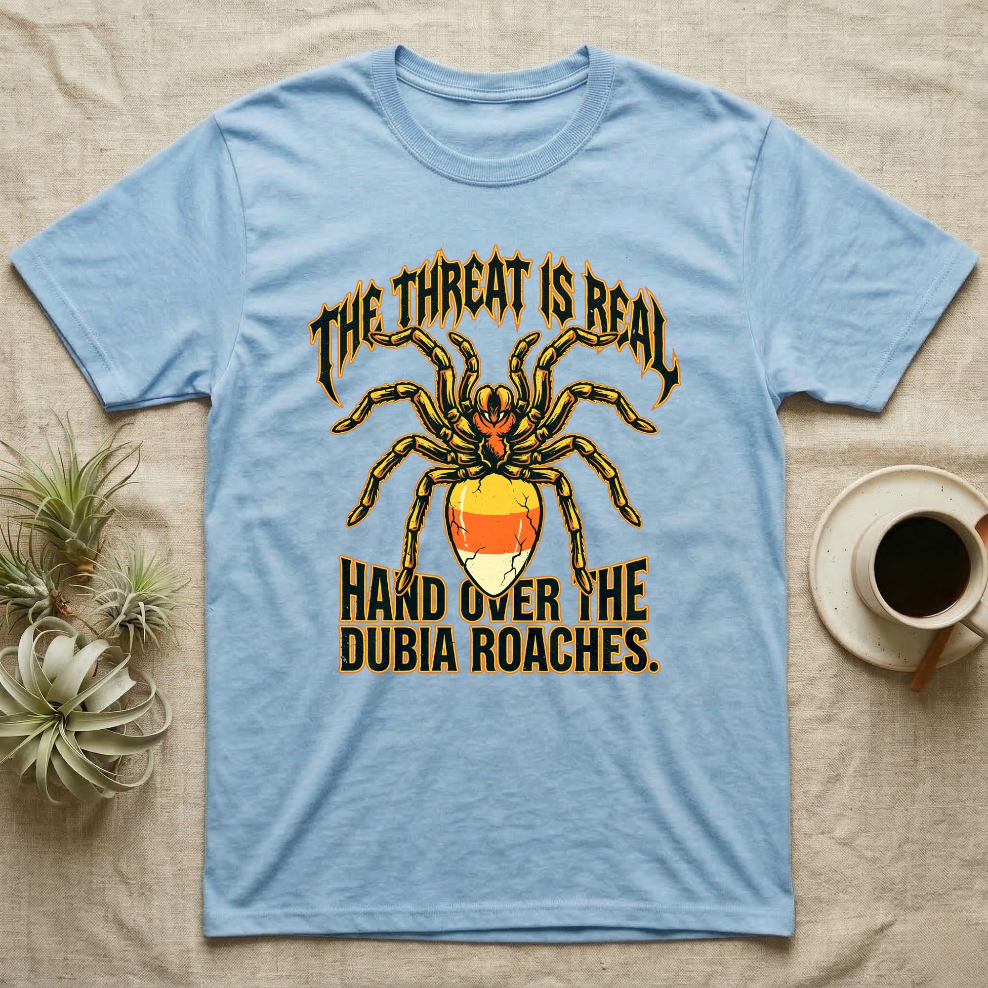 Tarantula Threat Dubia Roaches T-Shirt in Light Blue — Metal-style tarantula in threat posture with a candy-corn abdomen, "The Threat Is Real, Hand Over the Dubia Roaches."