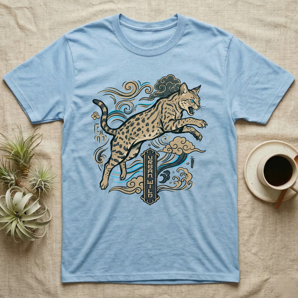 Light blue t-shirt with leaping spotted cat and Japanese-inspired clouds.